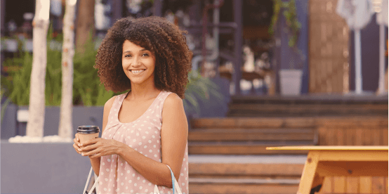 switch to synergy -woman shopping and enjoying her coffee