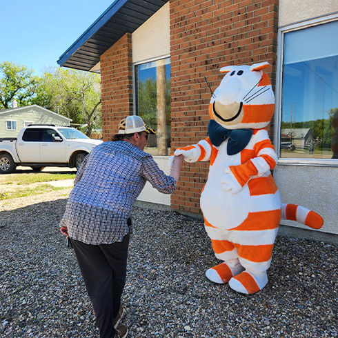 Fat Cat meeting a new friend during member appreciation day at our Marshall branch