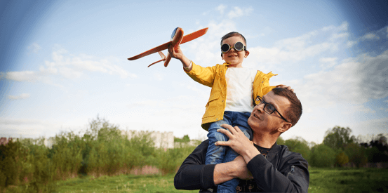 Father and son playing with a toy airplane