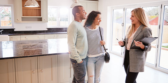 Realtor Showing Couple Interested In Buying Around House